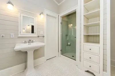 a white bathroom with a sink and a shower at 172 A Street in Inlet Beach