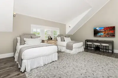 a white room with two beds and a fireplace at 172 A Street in Inlet Beach
