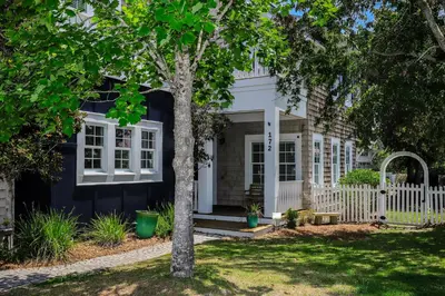 a house with a white fence and a tree at 172 A Street in Inlet Beach