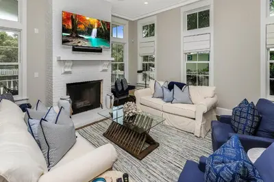 a living room with blue and white furniture and a fireplace at 172 A Street in Inlet Beach