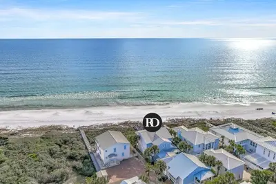 an aerial view of a beach with houses and the ocean at Sandy Boardwalk in Santa Rosa Beach
