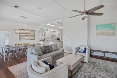 a living room with a couch and a dining room at Sandy Boardwalk in Santa Rosa Beach