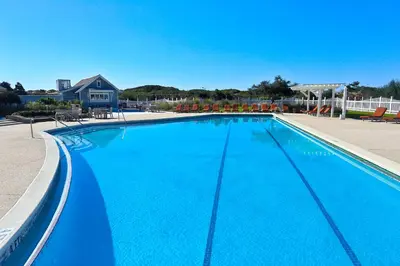 a large swimming pool with blue water at Compass Point 1, Unit 204 in Watersound Beach