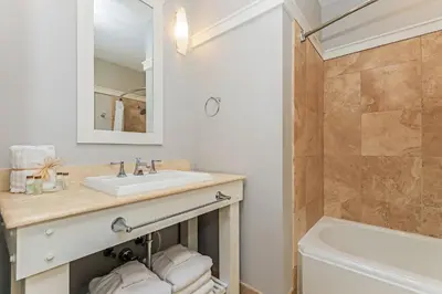 a bathroom with a sink and a toilet and a tub at Compass Point 1, Unit 204 in Watersound Beach