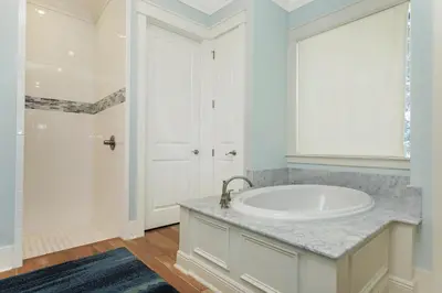 a white bathroom with a sink and a tub at Paradise Found in Santa Rosa Beach