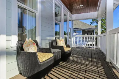two wicker chairs sitting on a screened porch at Paradise Found in Santa Rosa Beach