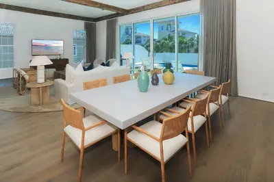 a dining room with a white table and chairs at Ocean in Inlet Beach