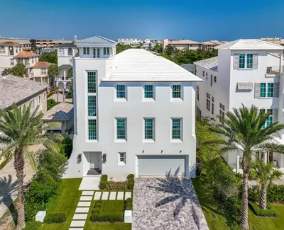 an aerial view of a white house with palm trees at Ocean in Inlet Beach