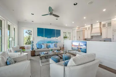 a living room with white furniture and a ceiling fan at 217 Gulf Bridge Lane in Watersound Beach