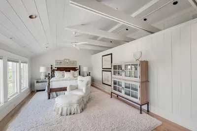 a bedroom with a bed and a couch and a table at 217 Gulf Bridge Lane in Watersound Beach