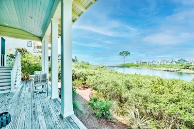 a porch of a house with a view of a river at 217 Gulf Bridge Lane in Watersound Beach
