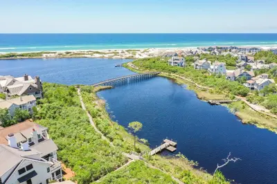 an aerial view of a river with houses and the ocean at 217 Gulf Bridge Lane in Watersound Beach
