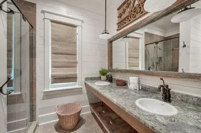 a bathroom with two sinks and a mirror at 217 Gulf Bridge Lane in Watersound Beach