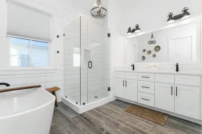 a white bathroom with a tub and a shower at Sonshine by the Sea in Santa Rosa Beach