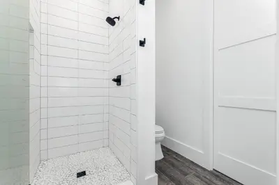 a bathroom with a shower with a toilet at Sonshine by the Sea in Santa Rosa Beach