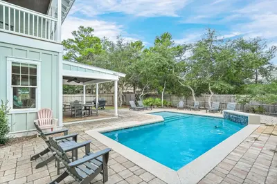a swimming pool in the backyard of a house at Sea-Rest in Inlet Beach