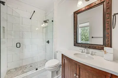 a bathroom with a toilet and a sink and a mirror at Sea-Rest in Inlet Beach