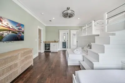 a living room with white walls and a staircase at Sea-Rest in Inlet Beach