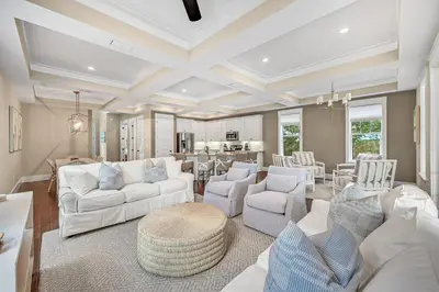 a living room with white furniture and a table at Sea-Rest in Inlet Beach