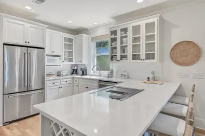 a kitchen with white cabinets and a white counter top at 48 Geoff Wilder in Inlet Beach