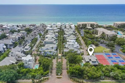 an aerial view of a resort with a white arrow pointing towards the ocean at 48 Geoff Wilder in Inlet Beach