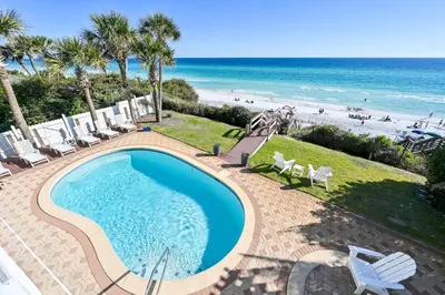a swimming pool with a view of the beach at Sunsational in Santa Rosa Beach