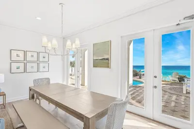 a dining room with a table and a view of the ocean at Sunsational in Santa Rosa Beach