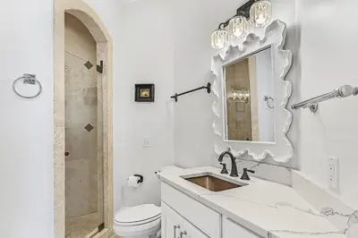 a bathroom with a sink and a toilet and a mirror at 15 Mathis Cove in Inlet Beach