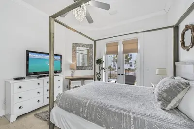 a bedroom with a bed and a television on a dresser at 15 Mathis Cove in Inlet Beach