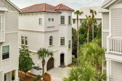 an aerial view of a white house with palm trees at 15 Mathis Cove in Inlet Beach