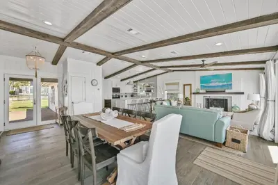 a dining room and kitchen with a table and chairs at 105 Pelican Circle in Inlet Beach