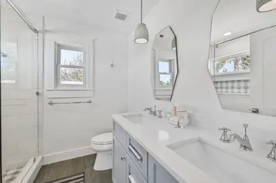 a white bathroom with a sink and a toilet at 105 Pelican Circle in Inlet Beach