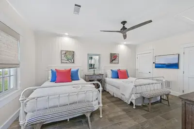 a bedroom with two beds and a ceiling fan at 105 Pelican Circle in Inlet Beach