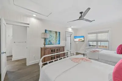 a white bedroom with a bed and a couch at 105 Pelican Circle in Inlet Beach