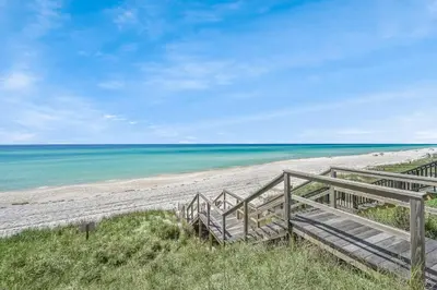 a staircase leading down to the beach at 105 Pelican Circle in Inlet Beach