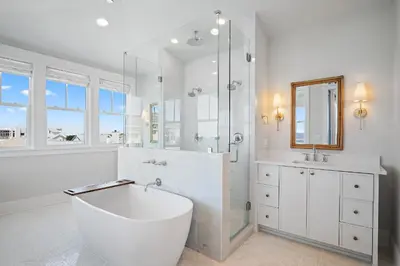 a white bathroom with a tub and a shower at Sunset Lounge in Santa Rosa Beach