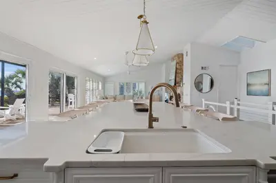 a white kitchen with a sink and a counter at 239 Pelican Circle in Inlet Beach