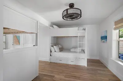 a bedroom with white walls and a bed in it at 239 Pelican Circle in Inlet Beach