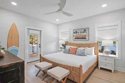 a bedroom with a bed and a surfboard in it at Emerald Isle in Santa Rosa Beach