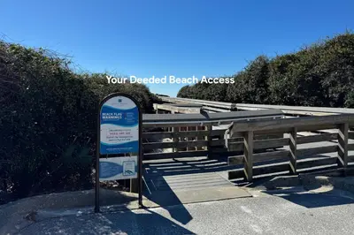 a sign that is next to a wooden fence at Emerald Isle in Santa Rosa Beach