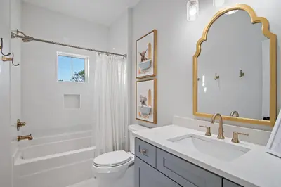 a white bathroom with a sink and a toilet at Emerald Isle in Santa Rosa Beach