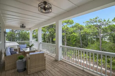 a screened porch with a view of the woods at Emerald Isle in Santa Rosa Beach