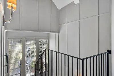 a hallway with a staircase and a window at 34 S Briland Lane Carriage House in Rosemary Beach