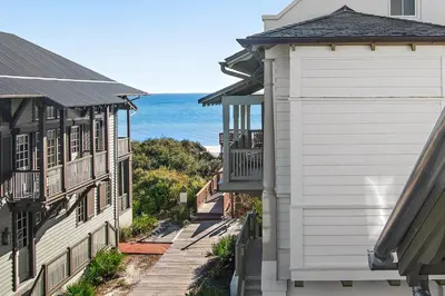 a view of the ocean from between two buildings at 34 S Briland Lane Carriage House in Rosemary Beach