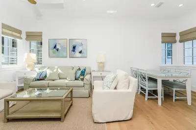 a living room with a couch and a table at Harp's Haven Carriage House in Rosemary Beach