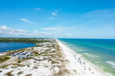an aerial view of a beach with umbrellas and the ocean at Harp's Haven Carriage House in Rosemary Beach