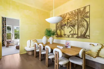 a dining room with a wooden table and chairs at 30A Showhouse in Rosemary Beach