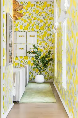 a hallway with yellow and white wallpaper and a plant at 30A Showhouse in Rosemary Beach