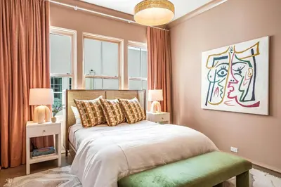 a bedroom with a bed and a large window at 30A Showhouse in Rosemary Beach