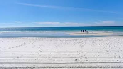 a group of people on a beach with the ocean at Eastern Shores 103 in Santa Rosa Beach
